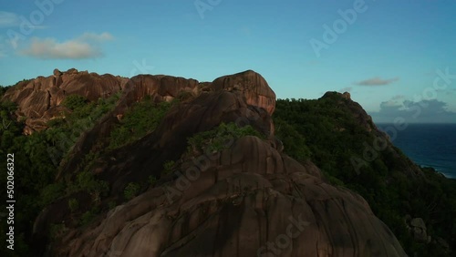 Aerial pull back and tilt down from top granite mountain and boulders