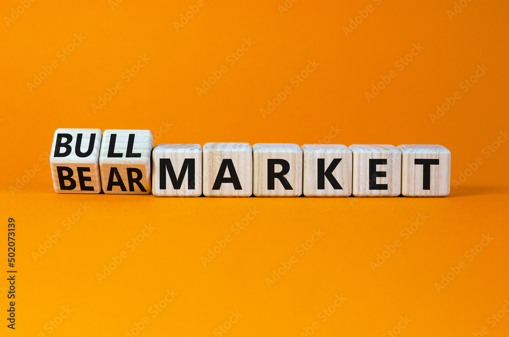 Bull or bear market symbol. Turned wooden cubes and changed concept words Bear market to Bull market. Beautiful orange table orange background, copy space. Business bull or bear market concept. Bull or bear market symbol. Turned wooden cubes and changed concept words Bear market to Bull market. Beautiful orange table orange background, copy space. Business bull or bear market concept.