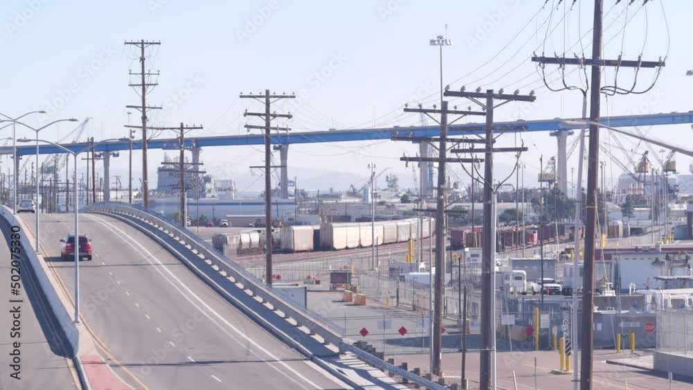 Industrial area, manufacturing or production district in San Diego, California USA. Coronado bridge and cars traffic. Fabrication and transportation infrastructure. Power lines or wires.