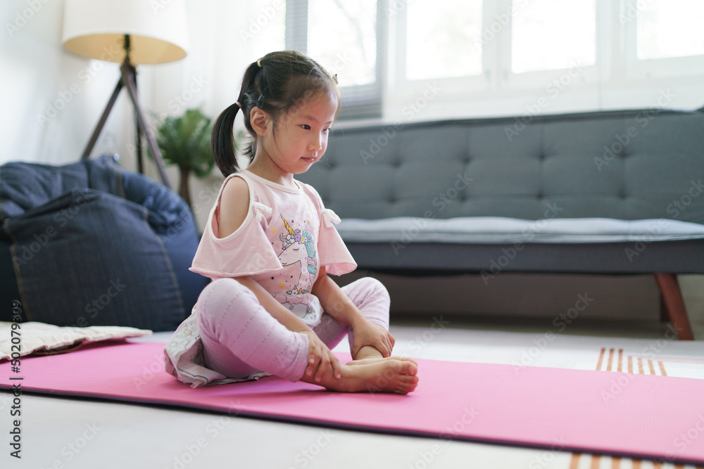 Asian girl kid exercise by practice YOGA posture at the living room. Asian girl kid exercise by practice YOGA posture at the living room.