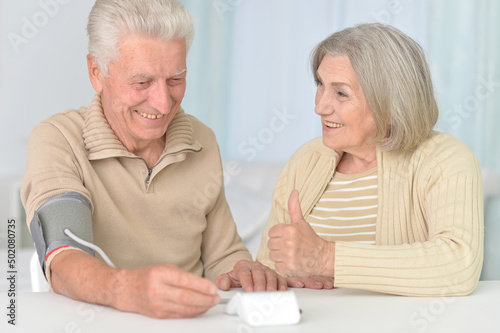senior couple measuring blood pressure together