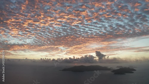 Aerial lock shot spectacular sunset in sky over Praslin, Seychelles