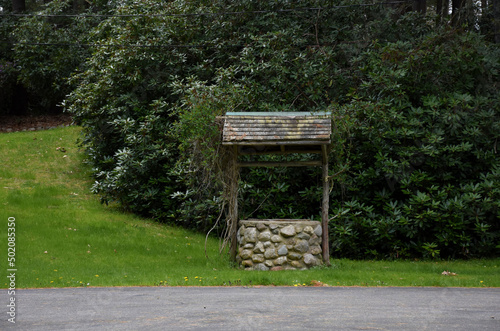 Rustic Wood and Stone Wishing Well on a Farm