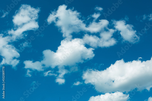White cumulus clouds in a blue sky. Backgrounds with a pattern of high-beam clouds. Weather  seasonality  ecology  clear sky. Peace 