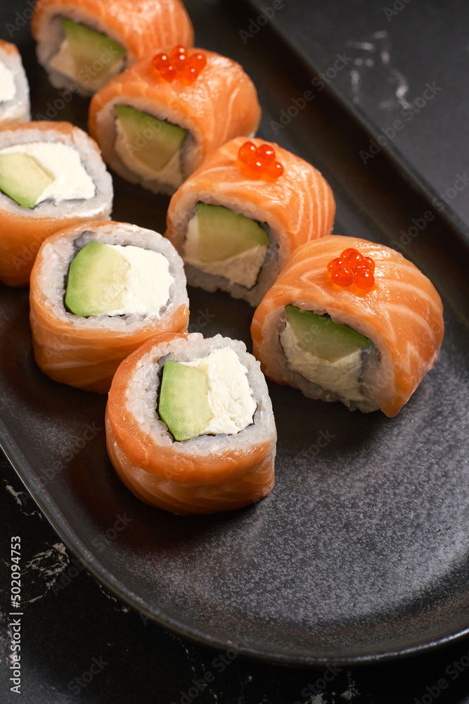 Philadelphia sushi roll with salmon, avocado, cream cheese. Sushi menu. Japanese food