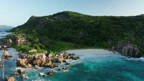 Aerial lock down over amazing solitary Anse Marron beach, La Digue