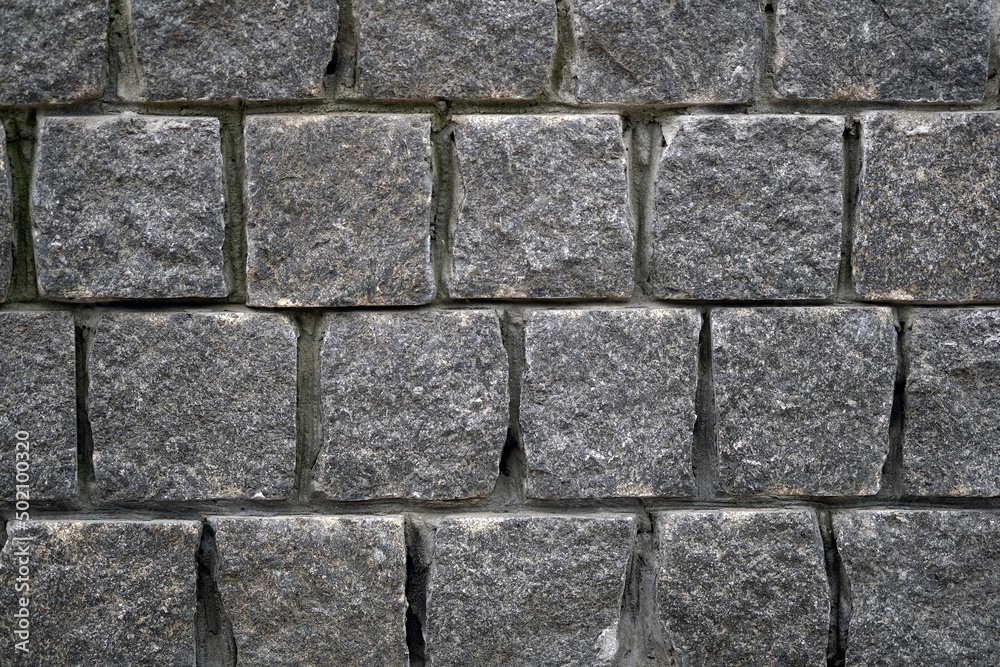 Gray stone wall. Square bricks fence. Abstract pattern of stone mosaic. Taupe Stone wall background texture. Gray stone wall. Square bricks fence. Abstract pattern of stone mosaic. Taupe Stone wall background texture.