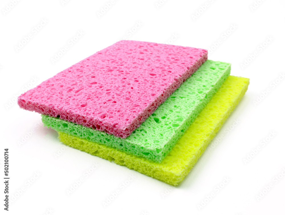 Moisture-absorbing washcloth for cleaning and washing dishes Cellulose. Bright colored washcloths for washing dishes, wet cleaning on a white background. Moisture-absorbing washcloth for cleaning and washing dishes Cellulose. Bright colored washcloths for washing dishes, wet cleaning on a white background.