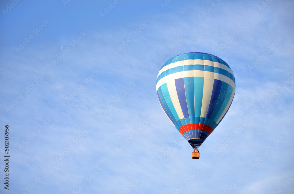 beautiful blue and white hot air balloon in cloudy sky, copy space beautiful blue and white hot air balloon in cloudy sky, copy space