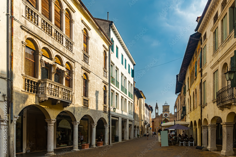View of typical old town street in historical center of Pordenone in sunny autumn day, Italy