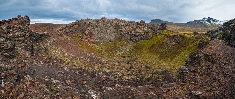 Spectacular volcanic view from Saxholl Crater, Snaefellsnes peninsula, West Iceland. Snaefellsjokull snowy volcano top in far.