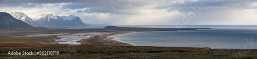 View during auto trip in West Iceland highlands  Snaefellsnes peninsula  Snaefellsjokull National Park. Spectacular volcanic tundra landscape with mountains  craters  rocky ocean coast.