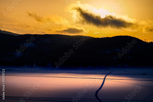 Sunset over a frozen lake