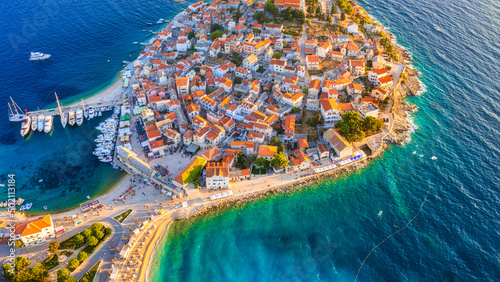 Fototapeta Naklejka Na Ścianę i Meble -  Primosten town, Croatia. View of the city from the air. Seascape with beach and old town. View from drone on the peninsula with houses. Travel and vacation image