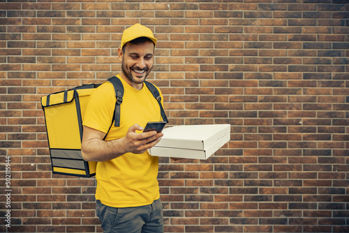 Photography Young man as a courier delivering food