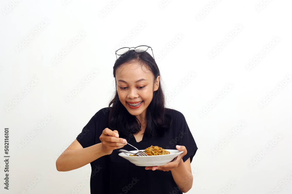 Asian young woman holding a plate of noodle. Isolated on white background Asian young woman holding a plate of noodle. Isolated on white background