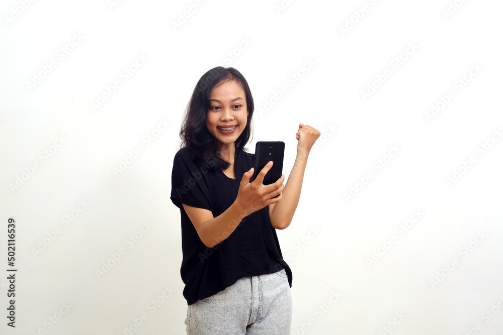 Successful asian young woman standing while holding a cell phone. Isolated on white background Successful asian young woman standing while holding a cell phone. Isolated on white background