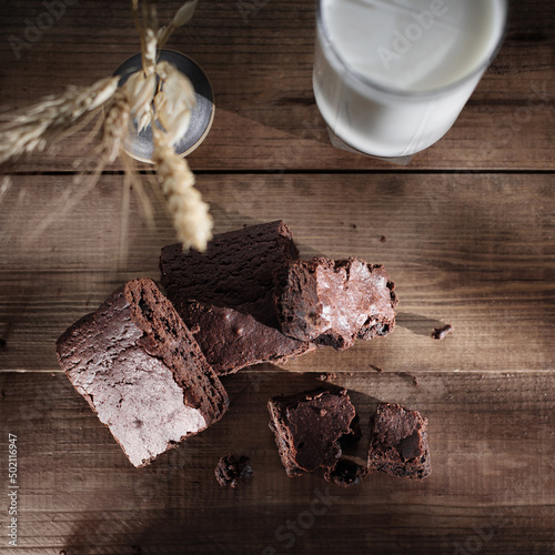 Brownie with milk on a wooden table