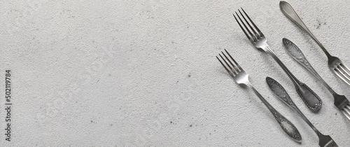 Silver forks on light background with space for text