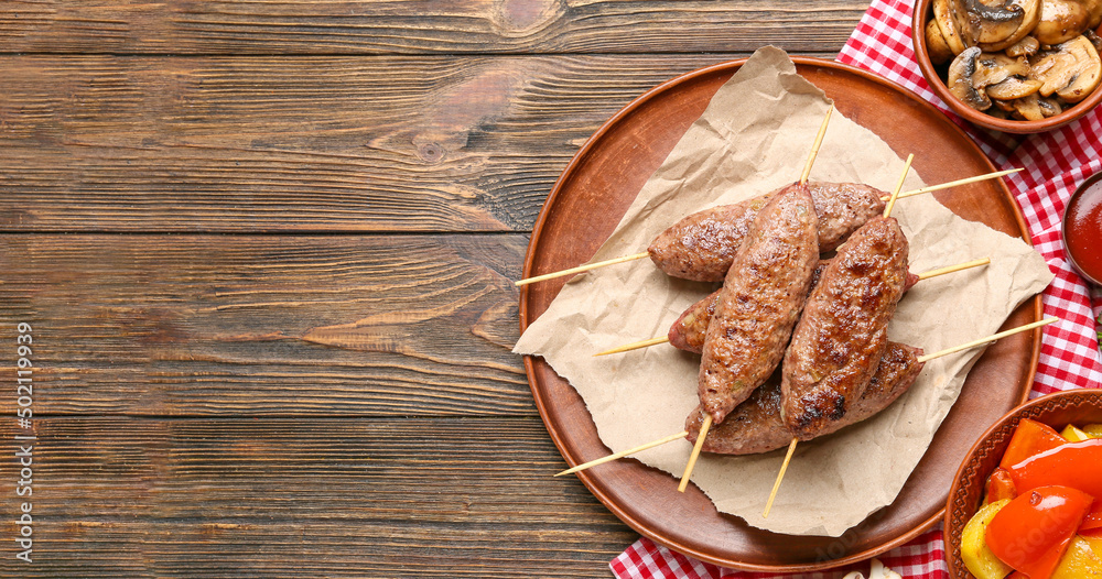 Plate tasty lula kebab on wooden background with space for text Plate tasty lula kebab on wooden background with space for text