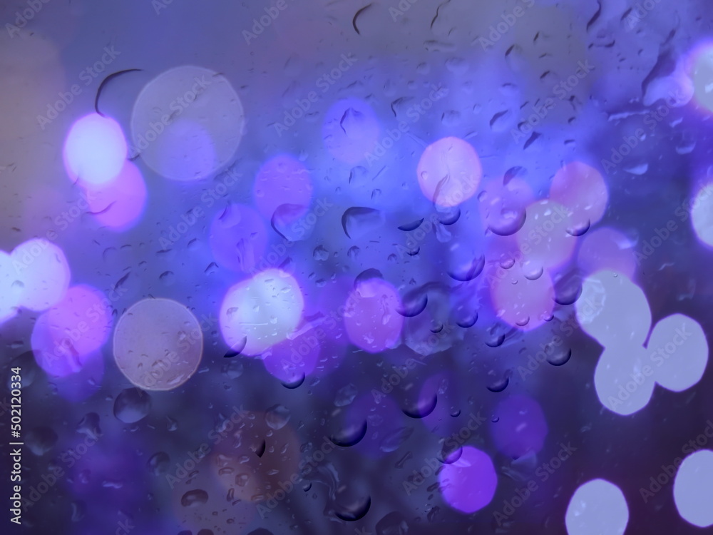 rainy drops on window glass ,city blurred evening light on window with rain drops nature background rainy drops on window glass ,city blurred evening light on window with rain drops nature background