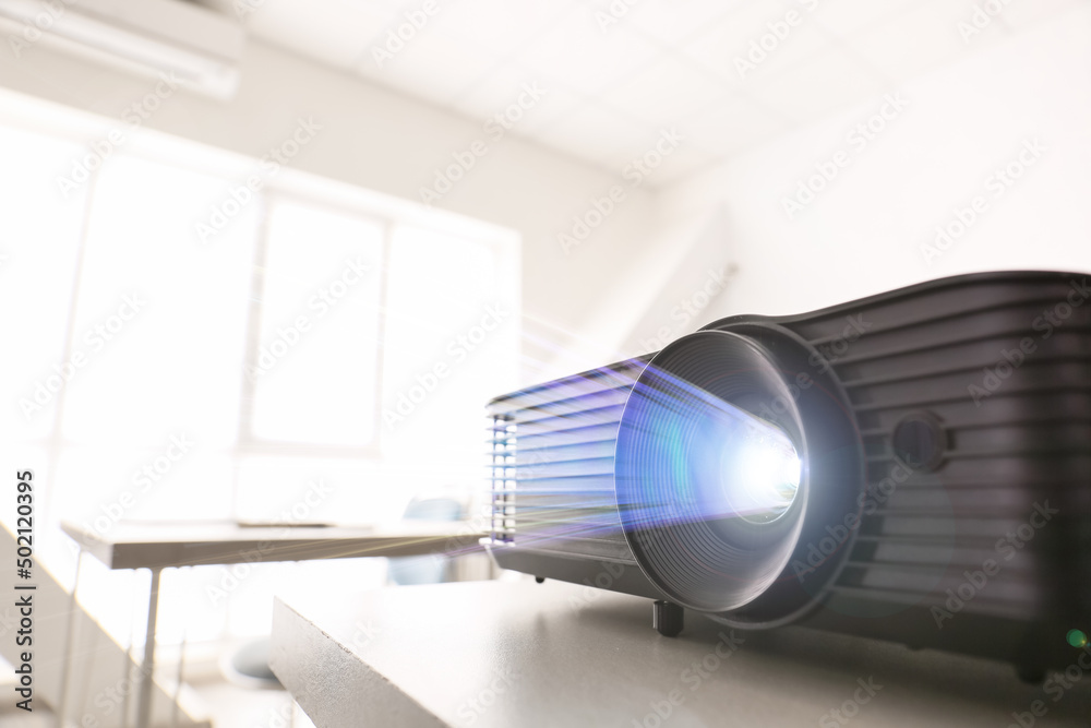 Naklejka premium Video projector on table in conference hall