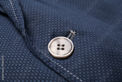 Closeup view of button on stylish clothes