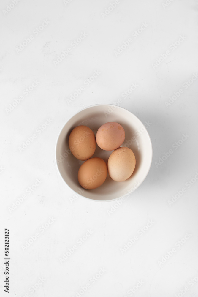 Eggs in a white bowl, brown eggs in a ceramic bowl, farm fresh eggs 