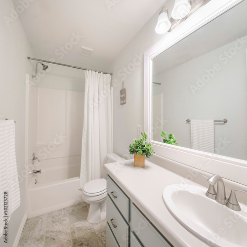 Square Windowless white minimalist bathroom interior with marble tile flooring