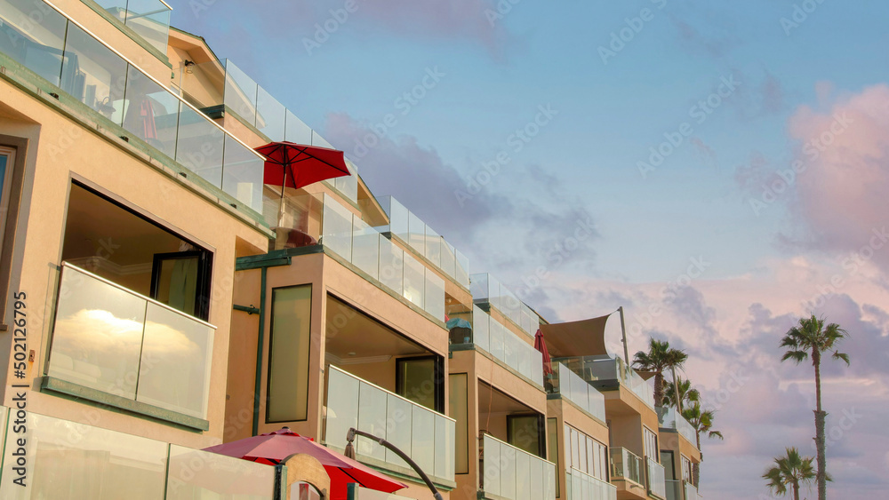 Panorama Puffy clouds at sunset Beach house hotel building in a low angle view at Oceanside, Cal