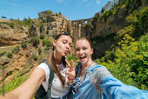 Tourist girl on the background of the famous bridge in Ronda, Spain