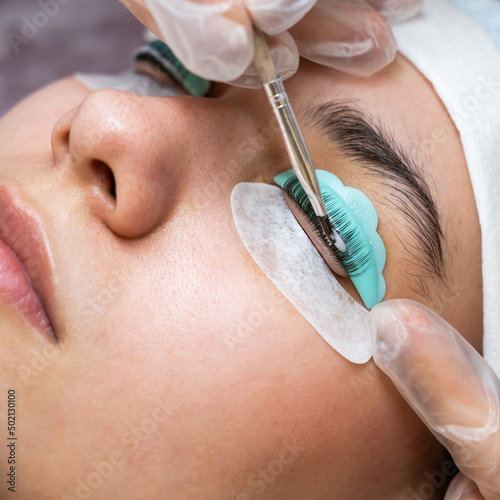 Close-up portrait of a woman on eyelash lamination procedure. 