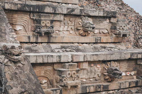 Details at the Temple of Quetzalcoatl (the Feathered Serpent) at Teotihuacan ancient city and vast archeological site in Central Mexico. The pyramid is decorated with stone carvings of the deity.  photo