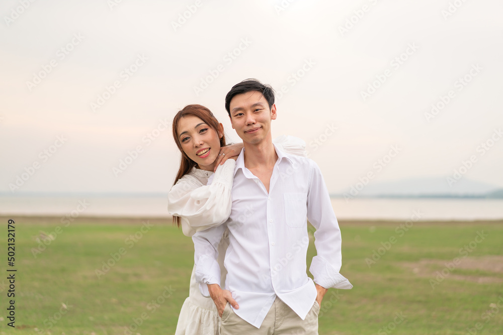 Happy young Asian couple in bride and groom clothing Happy young Asian couple in bride and groom clothing