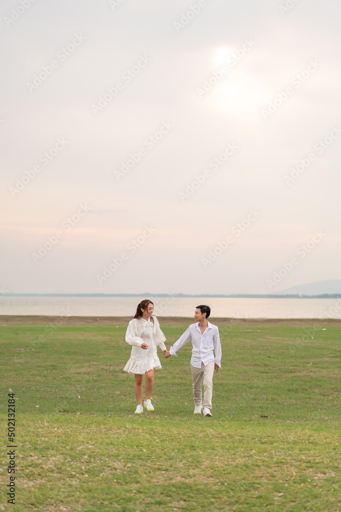 Happy young Asian couple in bride and groom clothing Happy young Asian couple in bride and groom clothing