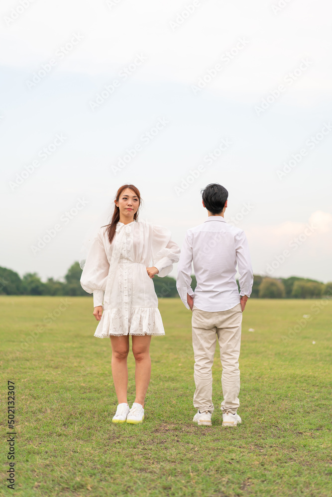 Happy young Asian couple in bride and groom clothing Happy young Asian couple in bride and groom clothing