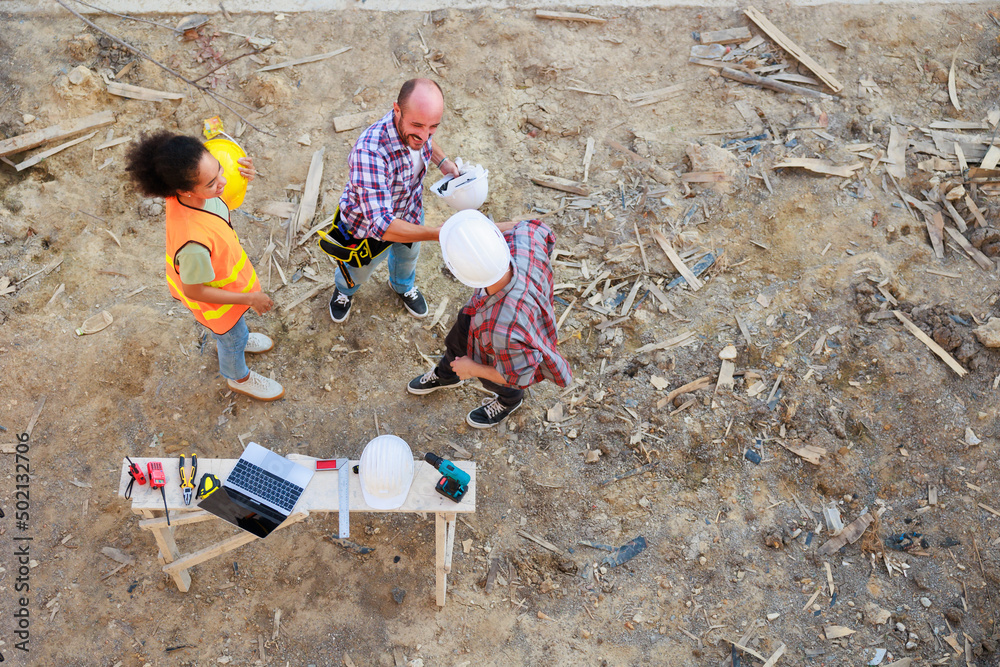 Hand together top view. Successful teamwork unity. Mechanical Engineer and construction team at house project underconstruction site. Hands meeting together Hand together top view. Successful teamwork unity. Mechanical Engineer and construction team at house project underconstruction site. Hands meeting together