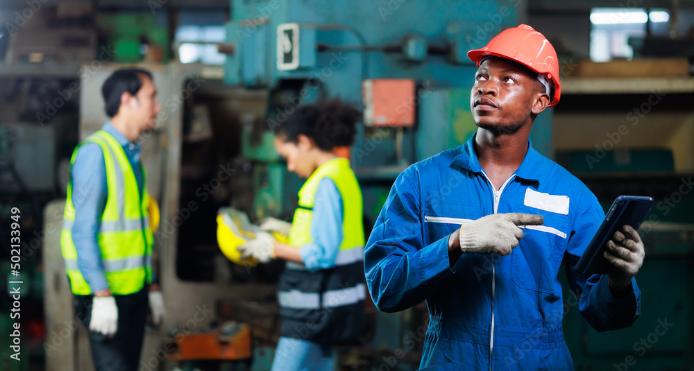 Black male electrician engineer working with digital tablet computer tool in his hands. Maintenance service Repair concept Black male electrician engineer working with digital tablet computer tool in his hands. Maintenance service Repair concept
