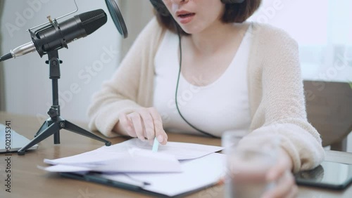 female presenters hosting audio online talk show, speak into microphone about news