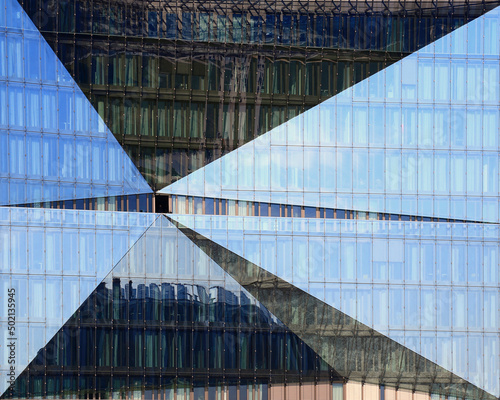 Photography Modern glass facade in Berlin with reflections of skyline and pavement