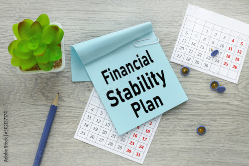 finansial stability plan. text on a blue sticker on a torn calendar.