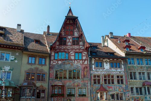 Historical tenement house (apartment building) with facade paintings and half timbered walls in an old town in Swiss city Stein am Rhein in Switzerland 
