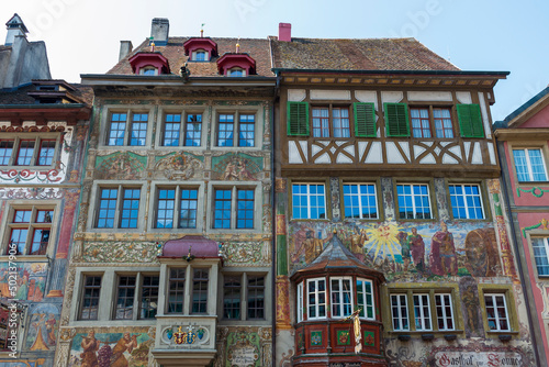 Historical tenement house (apartment building) with facade paintings and half timbered walls in an old town in Swiss city Stein am Rhein in Switzerland 
