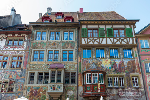 Historical tenement house (apartment building) with facade paintings and half timbered walls in an old town in Swiss city Stein am Rhein in Switzerland 

