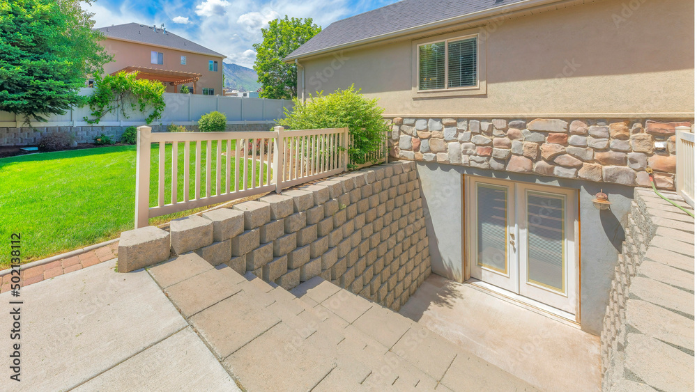 Panorama Whispy white clouds Basement entrance with glass panels on the double doors Panorama Whispy white clouds Basement entrance with glass panels on the double doors