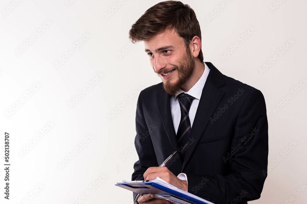 Young Businessman Holding Documents and Smiling Young Businessman Holding Documents and Smiling