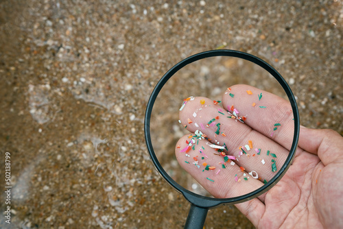 Quadro su tela Close up side shot of microplastics lay on people hand