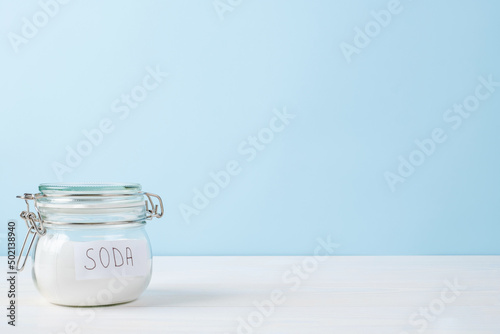 Jar of soda on a blue background, space for text. The concept organic stain remover photo