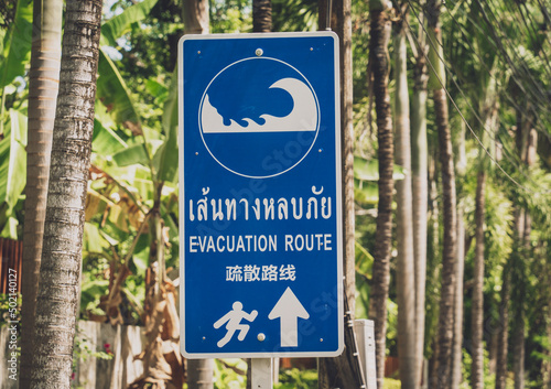 A sign showing a tsunami evacuation route at island in Thailand