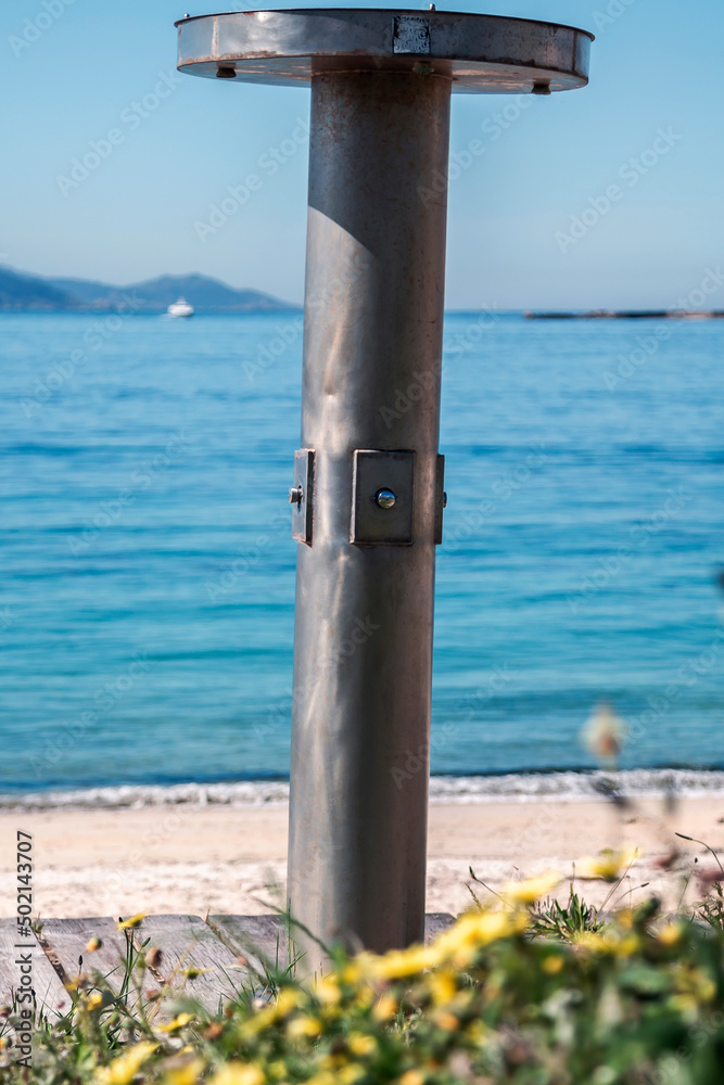 beach with showers and wooden walkway in galicia, spain beach with showers and wooden walkway in galicia, spain